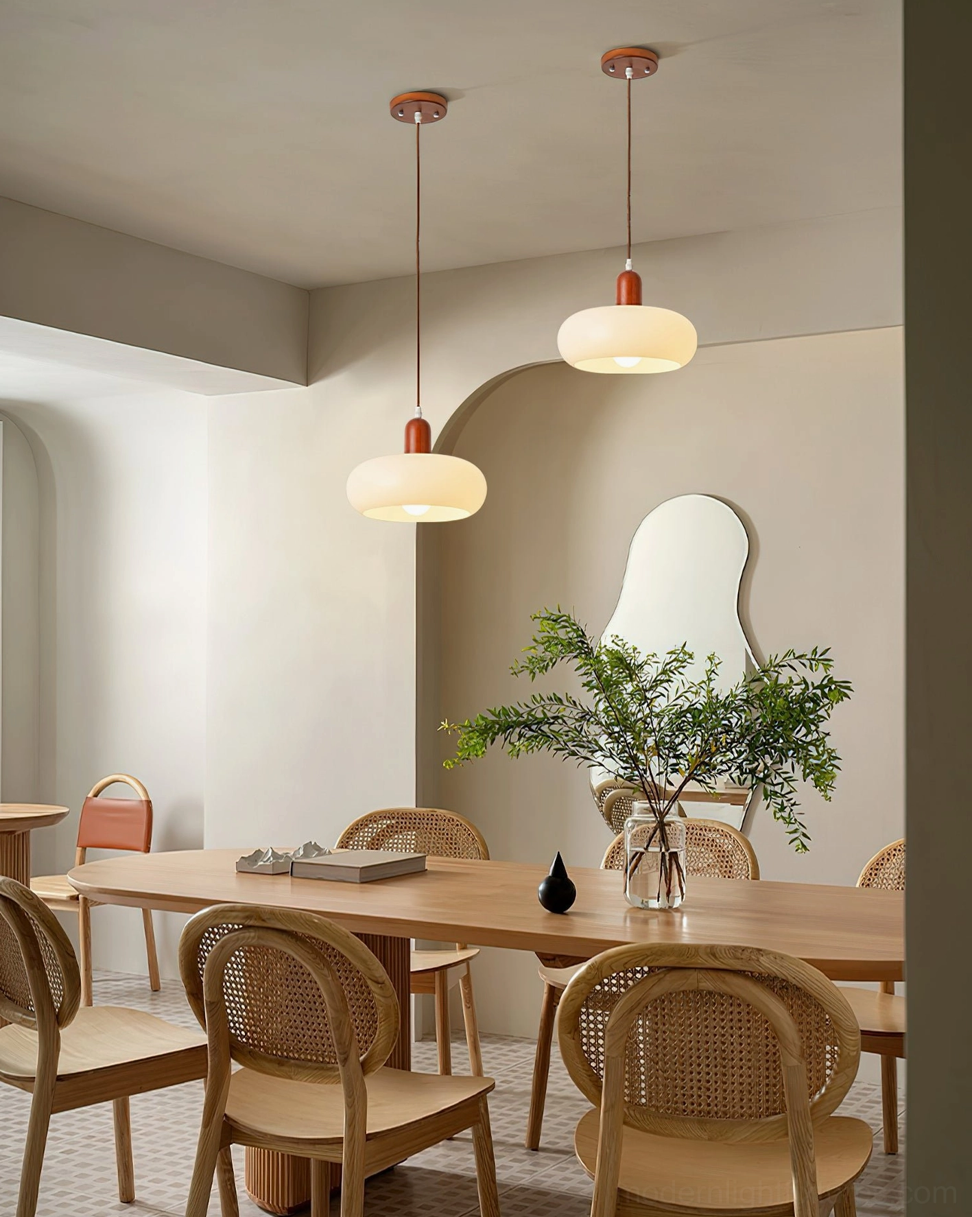 Multiple Rime pendant lamps suspended over wooden dining room table with rattan chairs, rustic Nordic aesthetic
