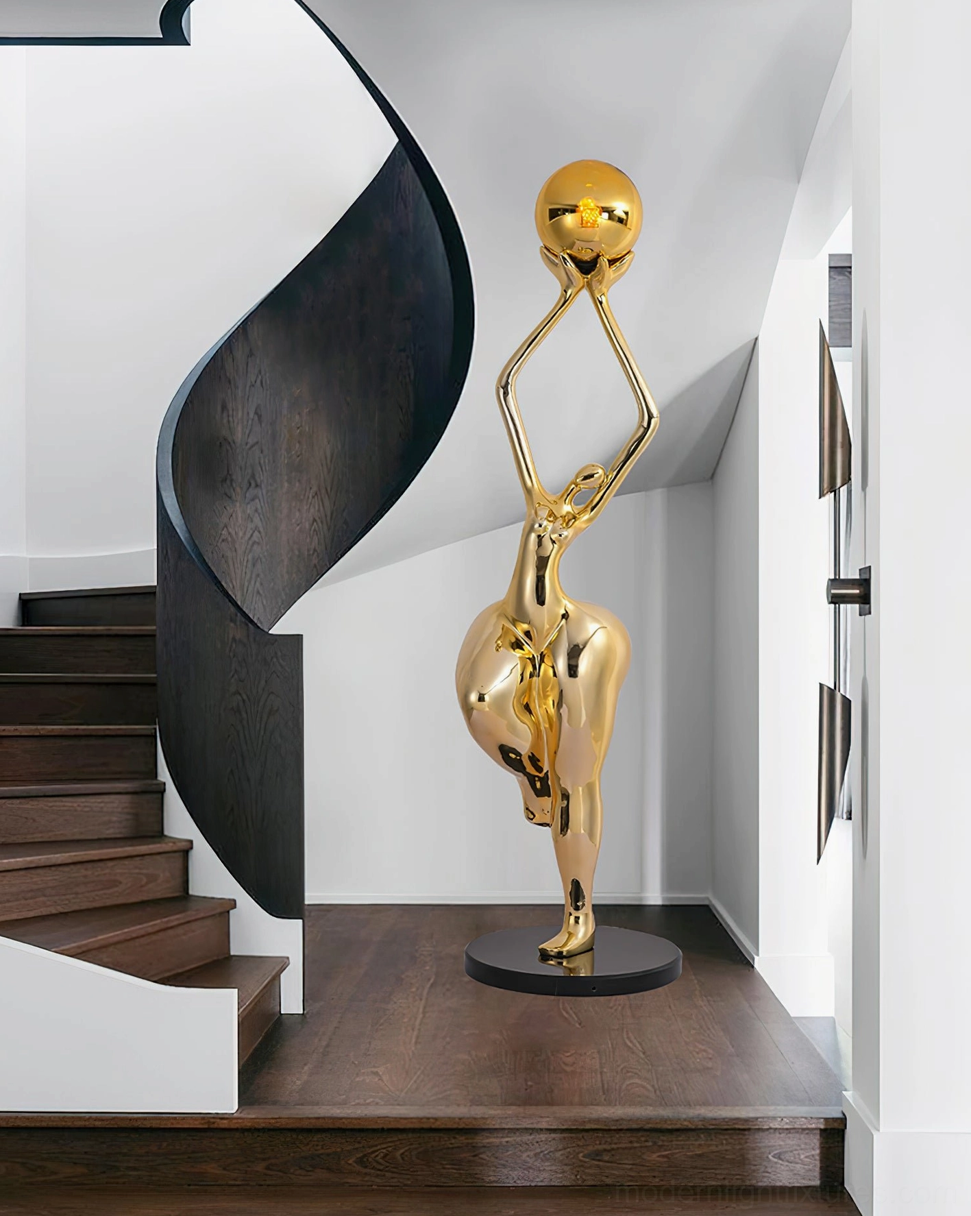 Gold polished Rina sculptural floor lamp three-quarter view on staircase with spherical golden shade, luxury home lighting