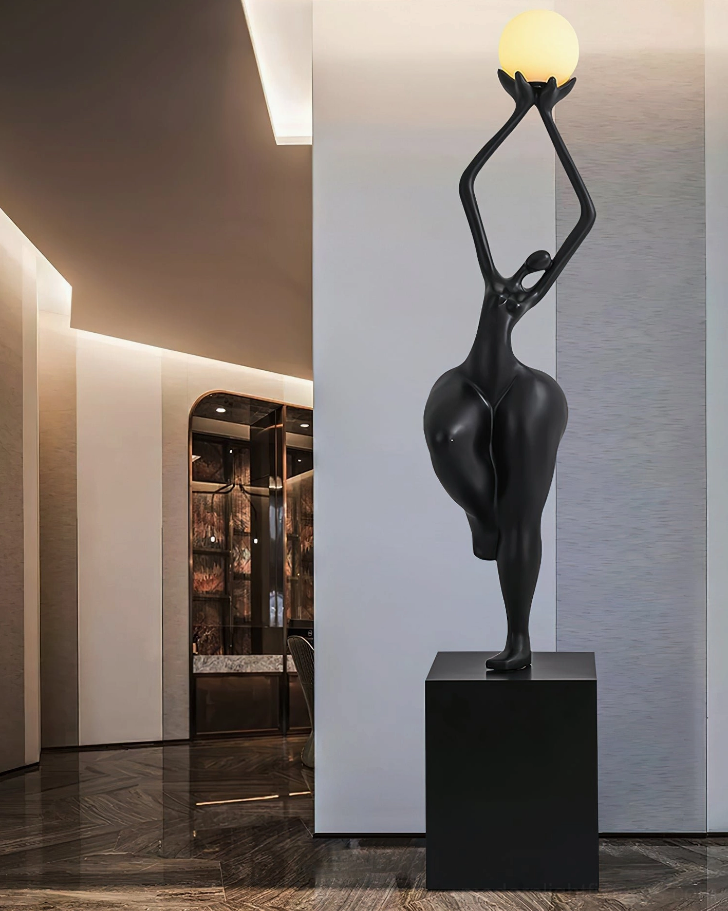 Black sculptural floor lamp three-quarter view in high-end residential hallway, elegant abstract female form reaching upward