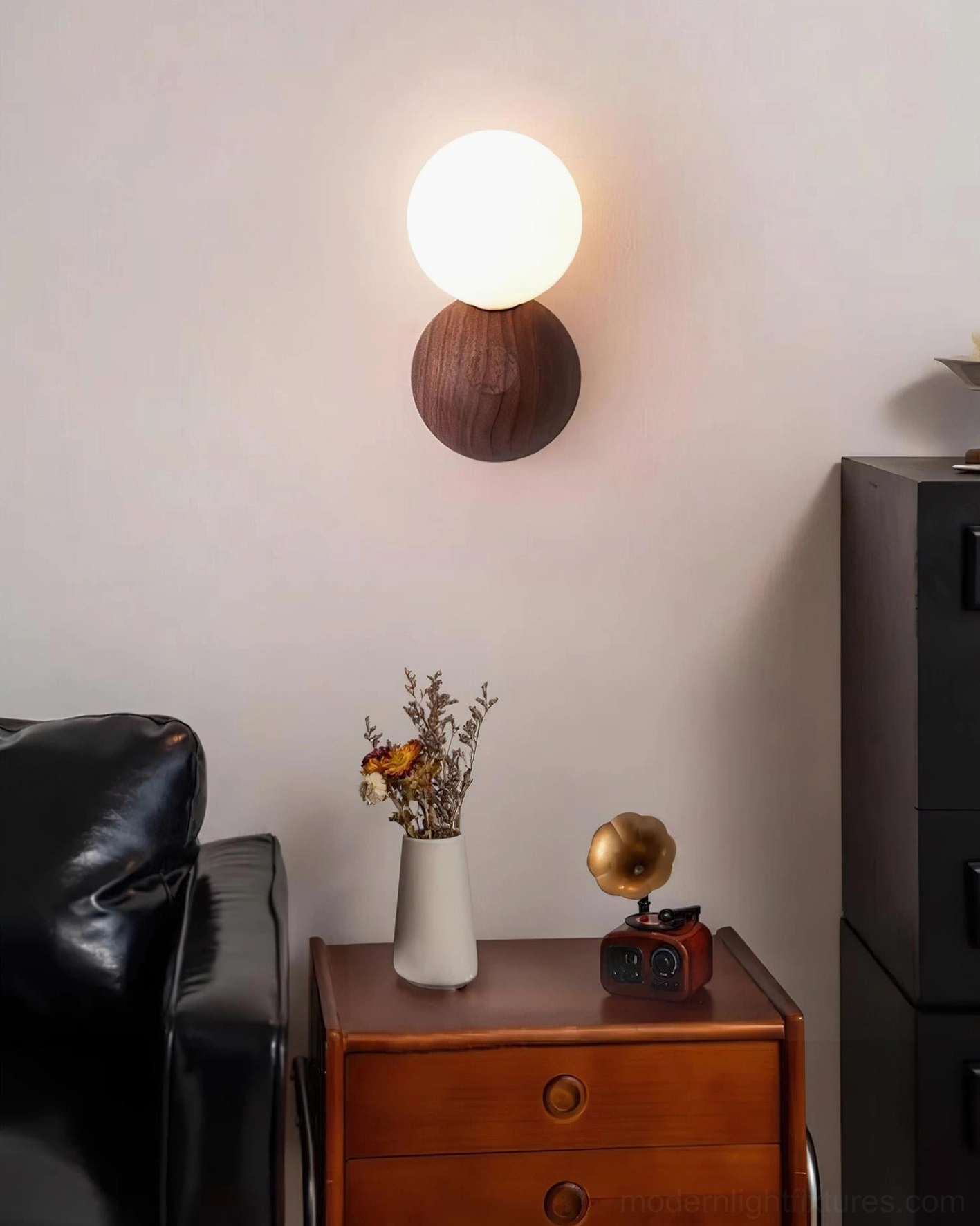 Ringo wood wall sconce positioned above side table with vinyl records and flower arrangements in retro home interior