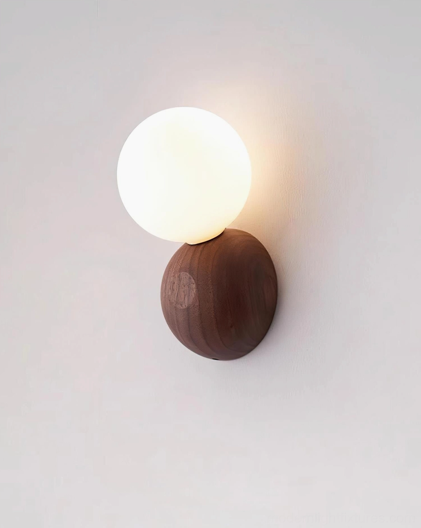 Close-up detail of Ringo wall sconce wood base showing natural grain texture and opal glass diffuser craftsmanship