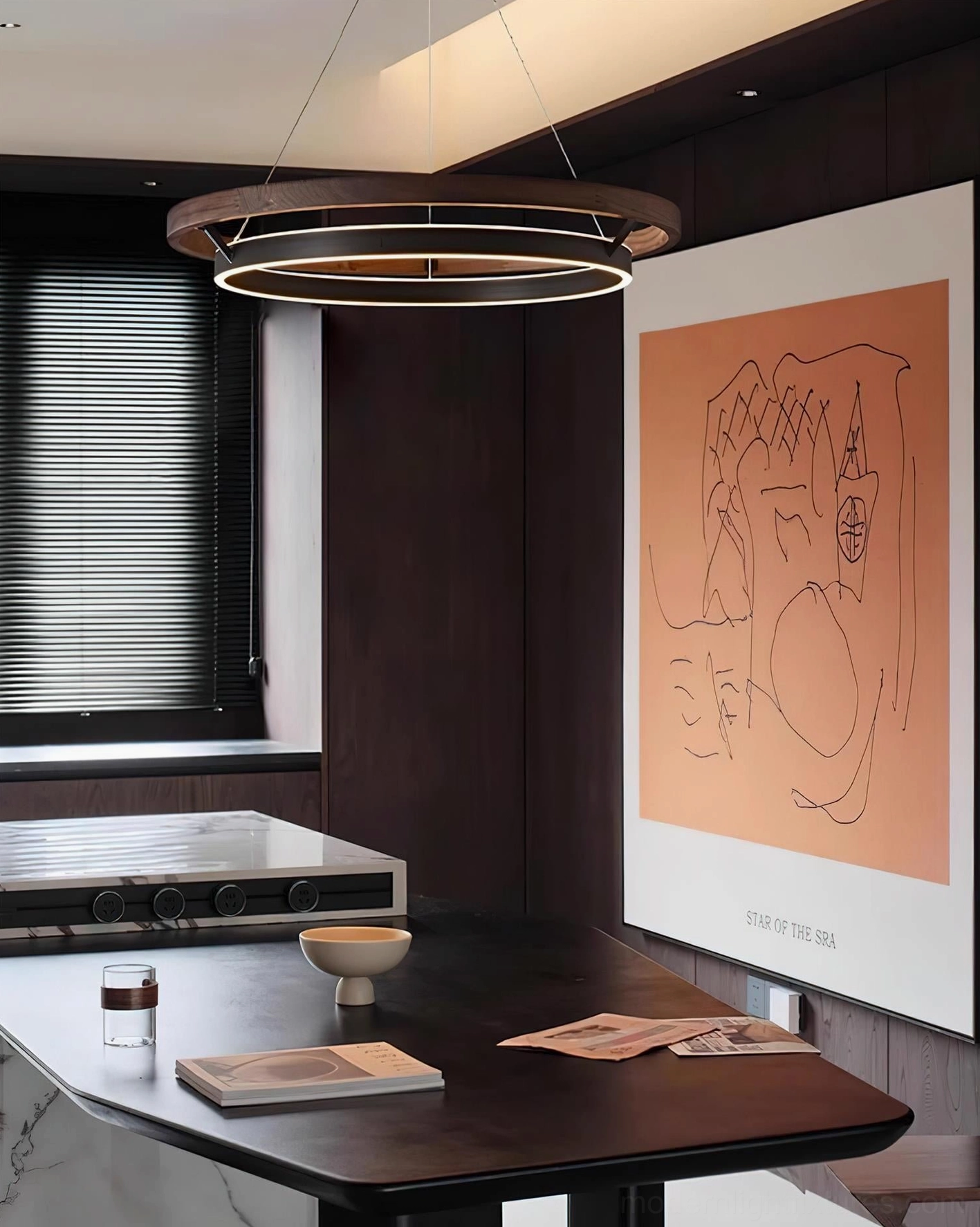 Dark modern dining space with Ringora dual-ring pendant chandelier suspended overhead