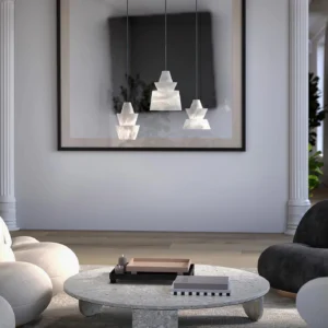 Multiple rinkle alabaster pendant lights installed in modern minimalist living room, hanging over round stone coffee table with warm neutral interior design