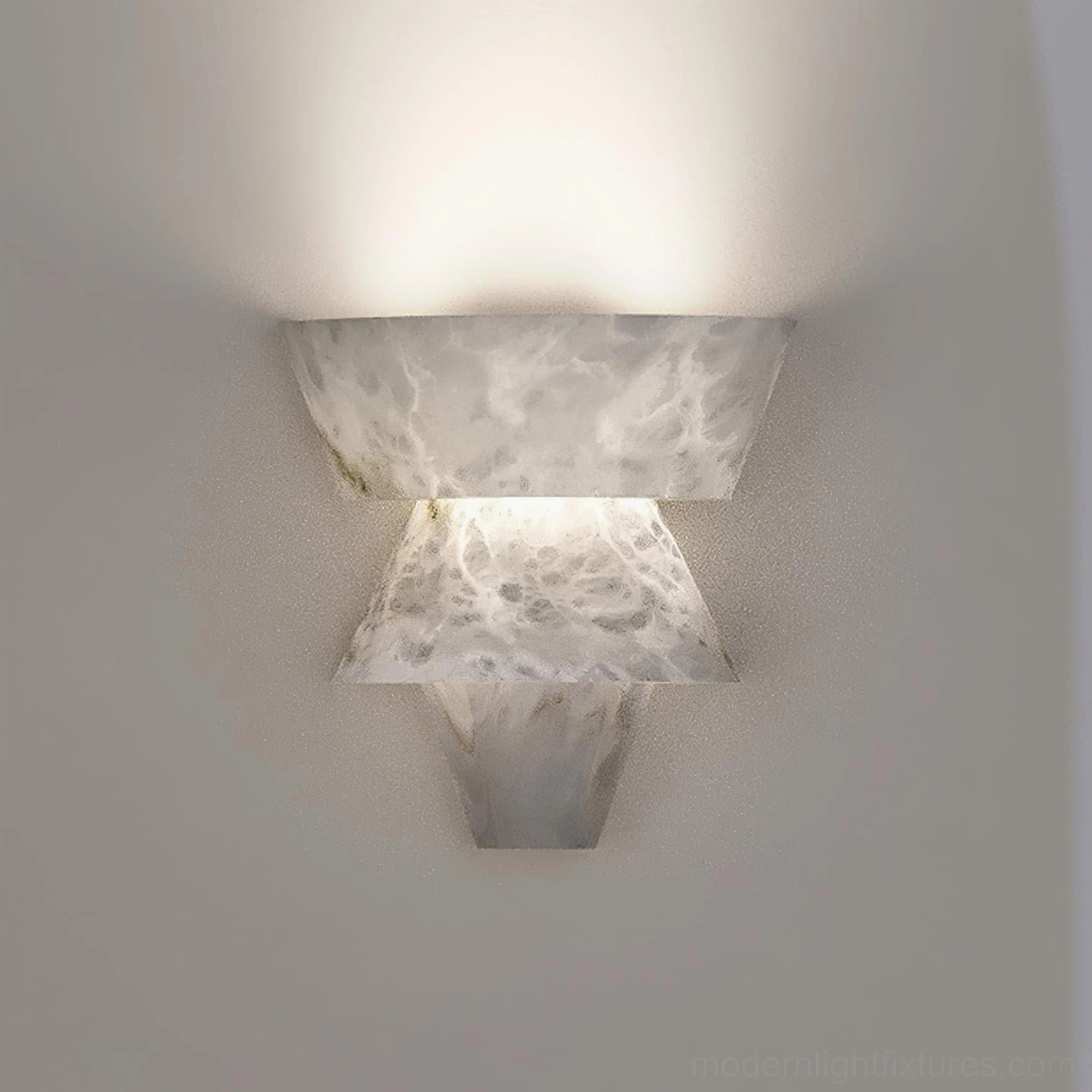 Rinkle alabaster wall lamp installed at eye level casting warm ambient light on neutral wall