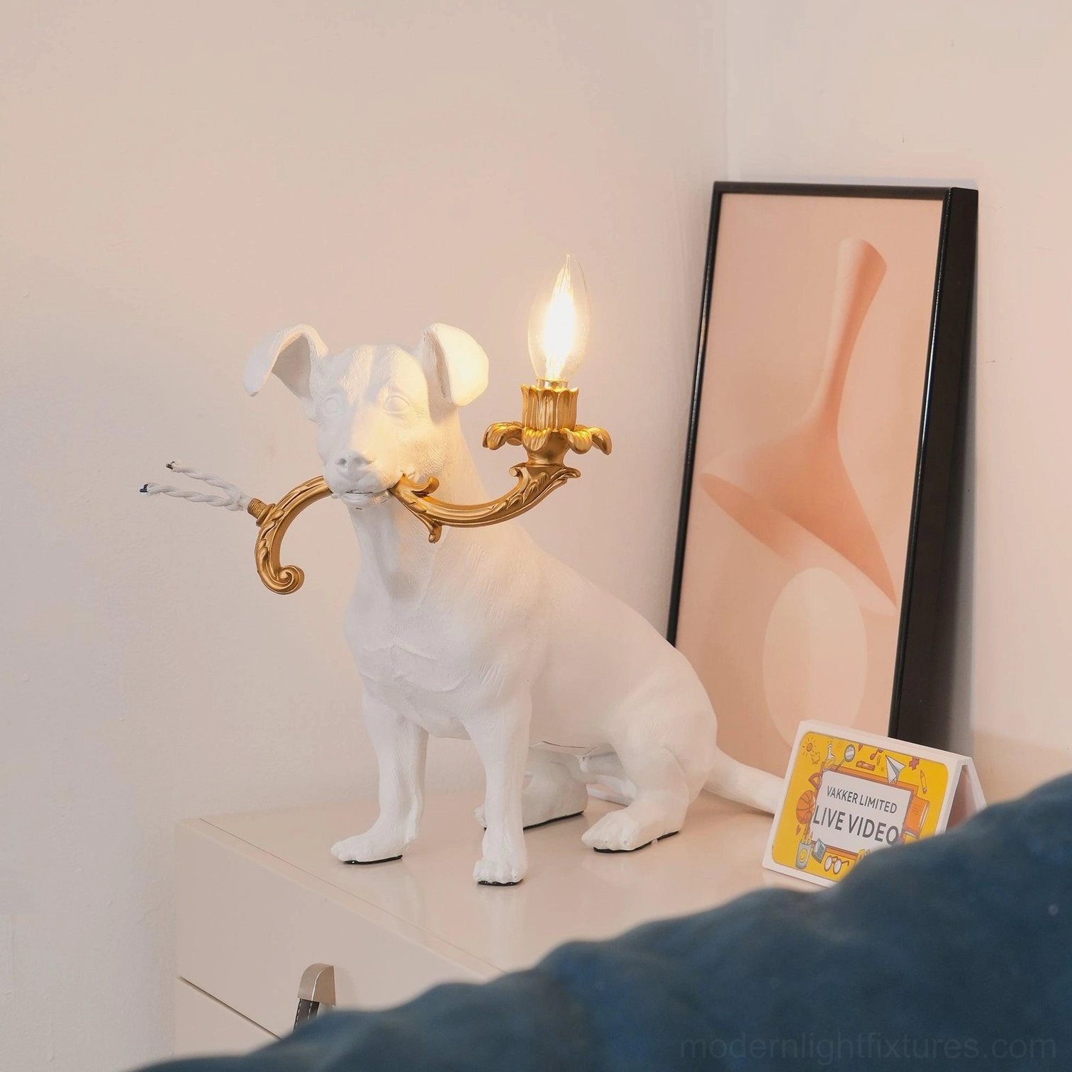 Rio dog table lamp design detail, white resin dog figure modern light fixture, gold metal accents sculptural quality