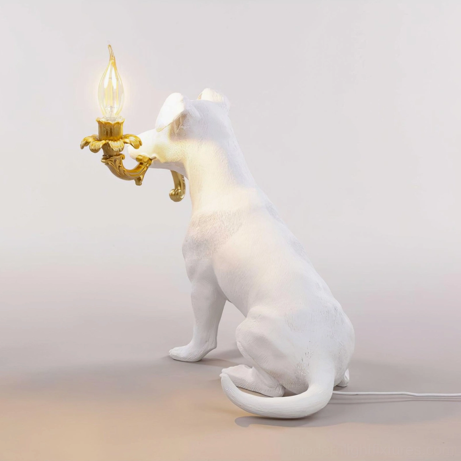 Rio dog table lamp side profile view, modern canine sculptural light fixture, white resin dog figure with gold candelabra