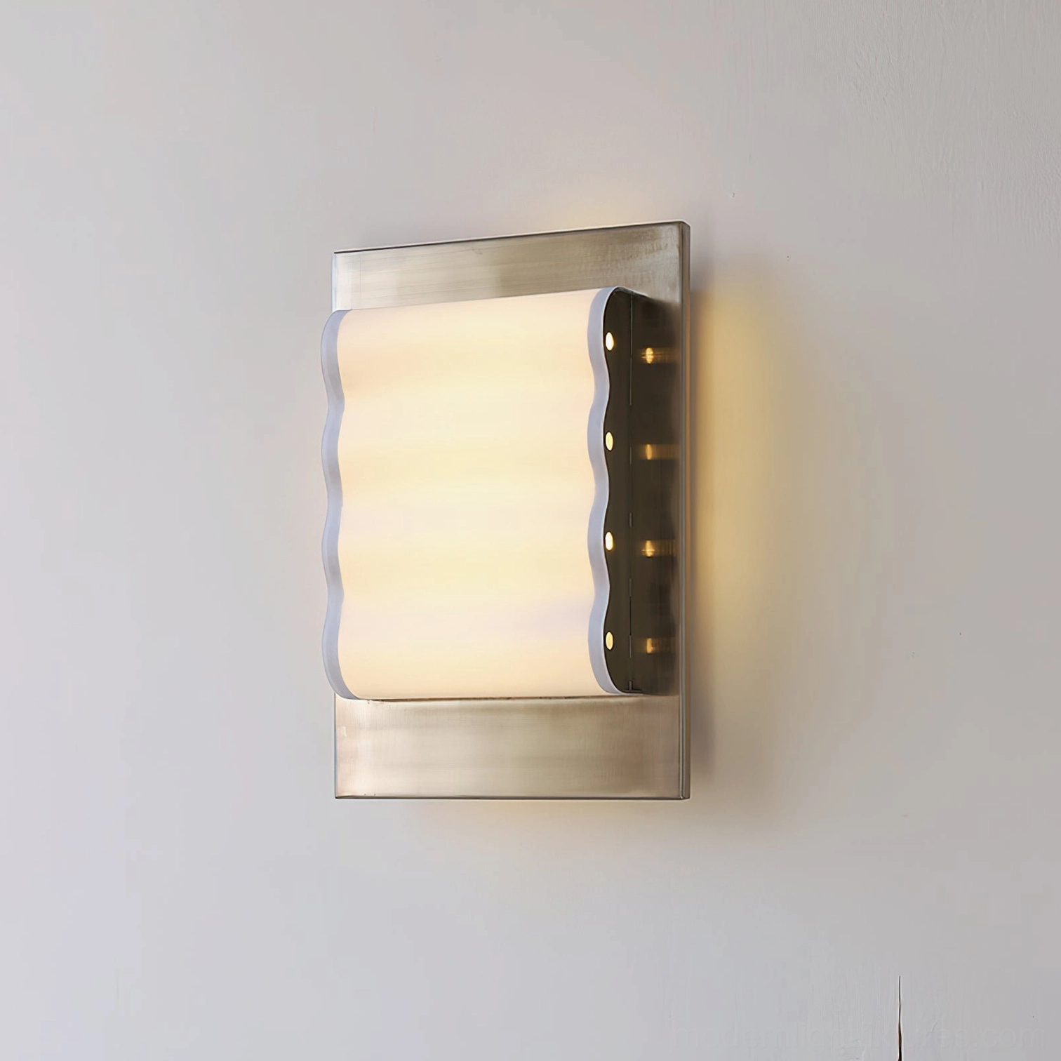 Contemporary ripple edge wall lamp with smooth wavy shade and brushed metal base white studio lighting