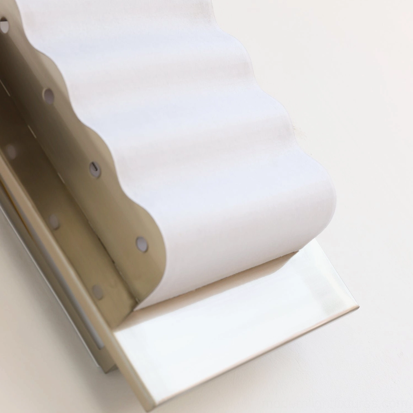 Contemporary ripple edge wall lamp with wavy acrylic shade and metal frame design feature shot