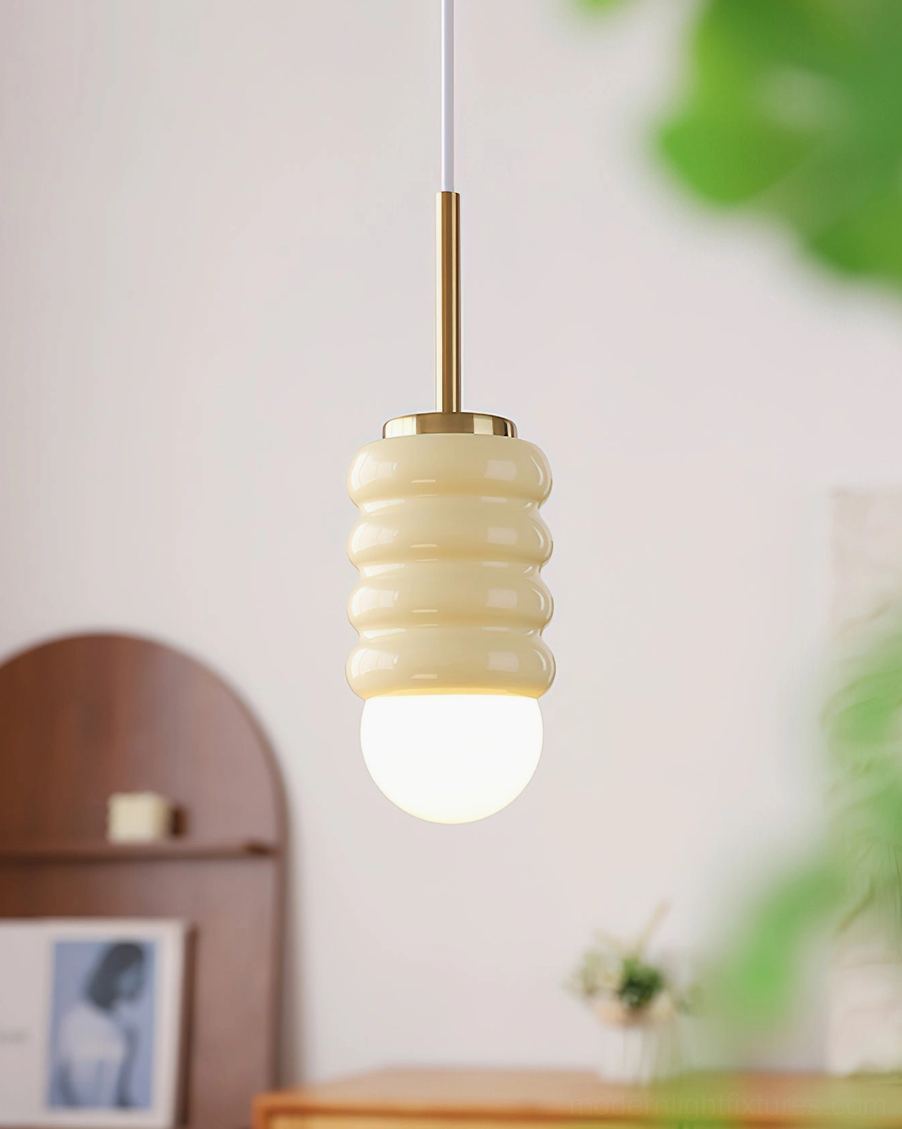 Ceramic pendant lamp in beige with brass gold hardware in vintage home interior, minimalist pendant light design