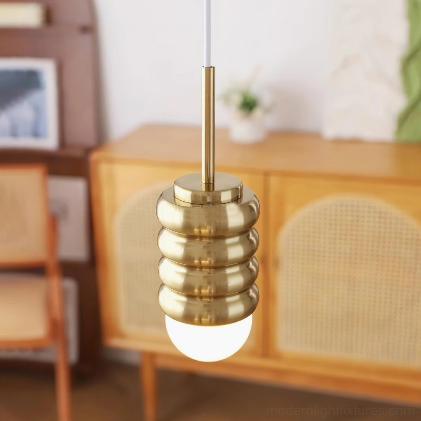 Gold brass metal pendant light with corrugated shade and brass hardware, vintage interior with warm glow