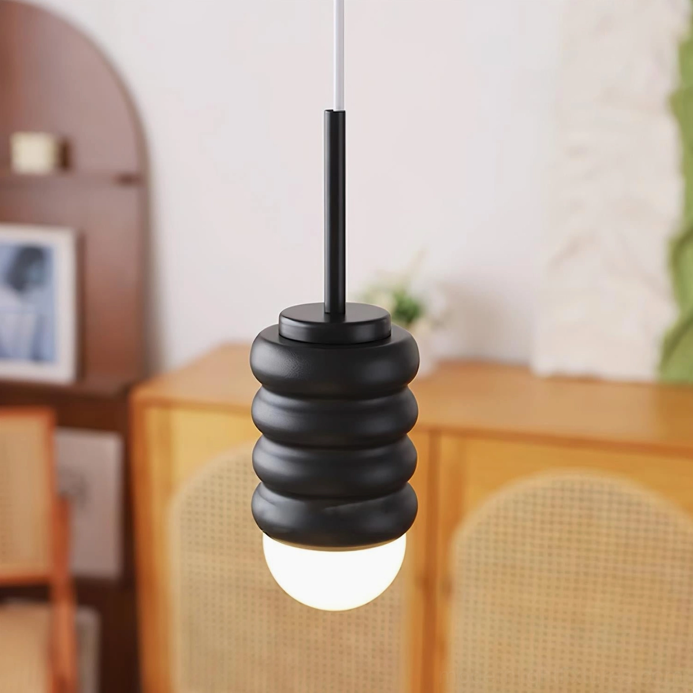Matte black metal mini pendant light with corrugated texture in contemporary home interior setting