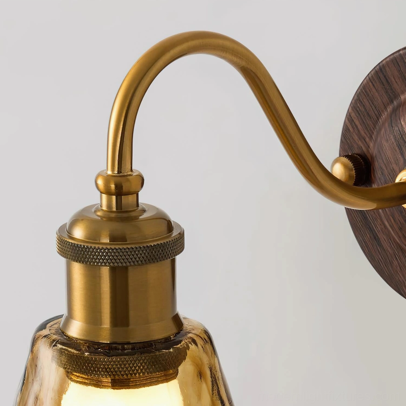 Amber glass wall lamp detail of shade texture showing hand-rippled surface and light warming properties