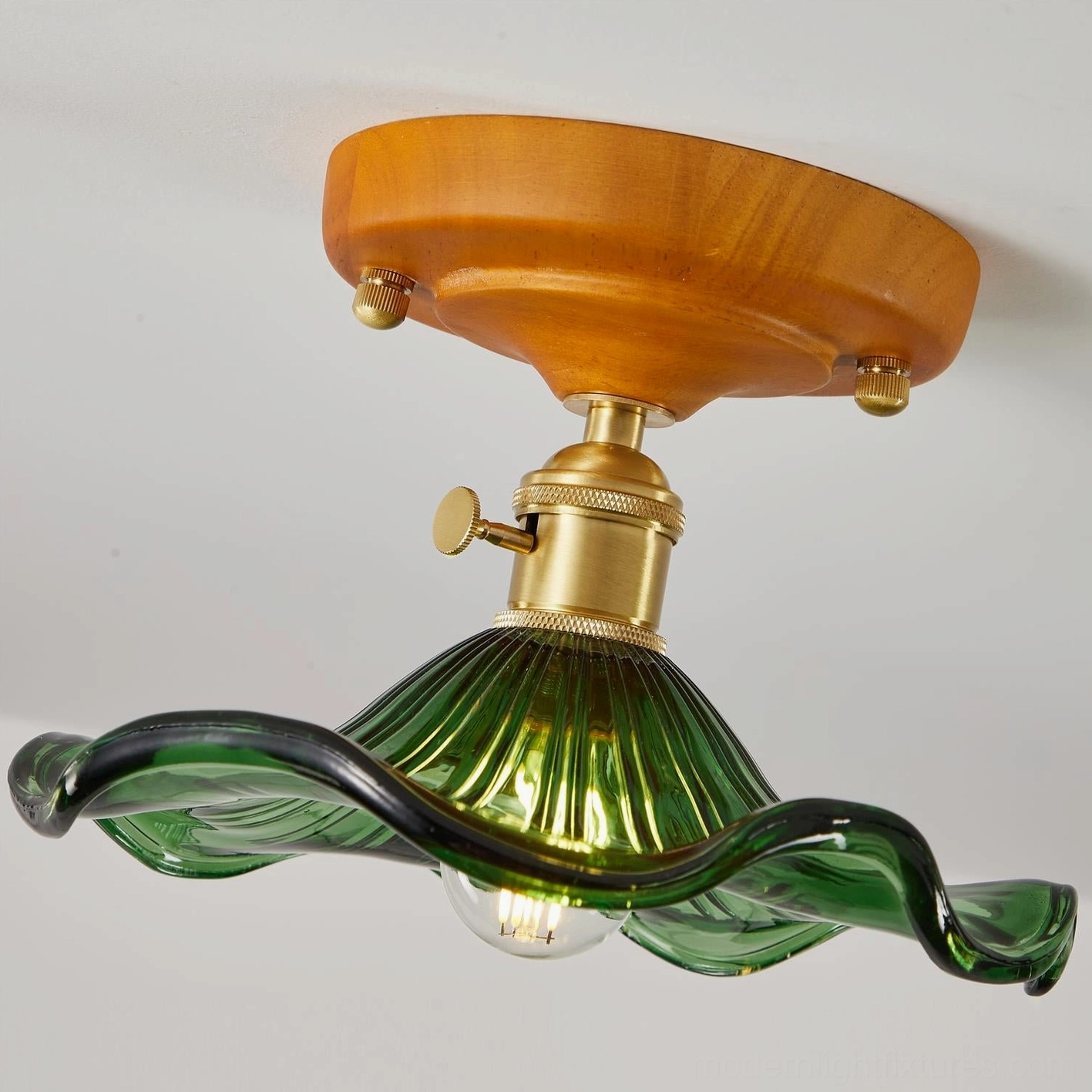 Texture detail of green wavy glass ceiling light shade showing ripple patterns and glass craftsmanship