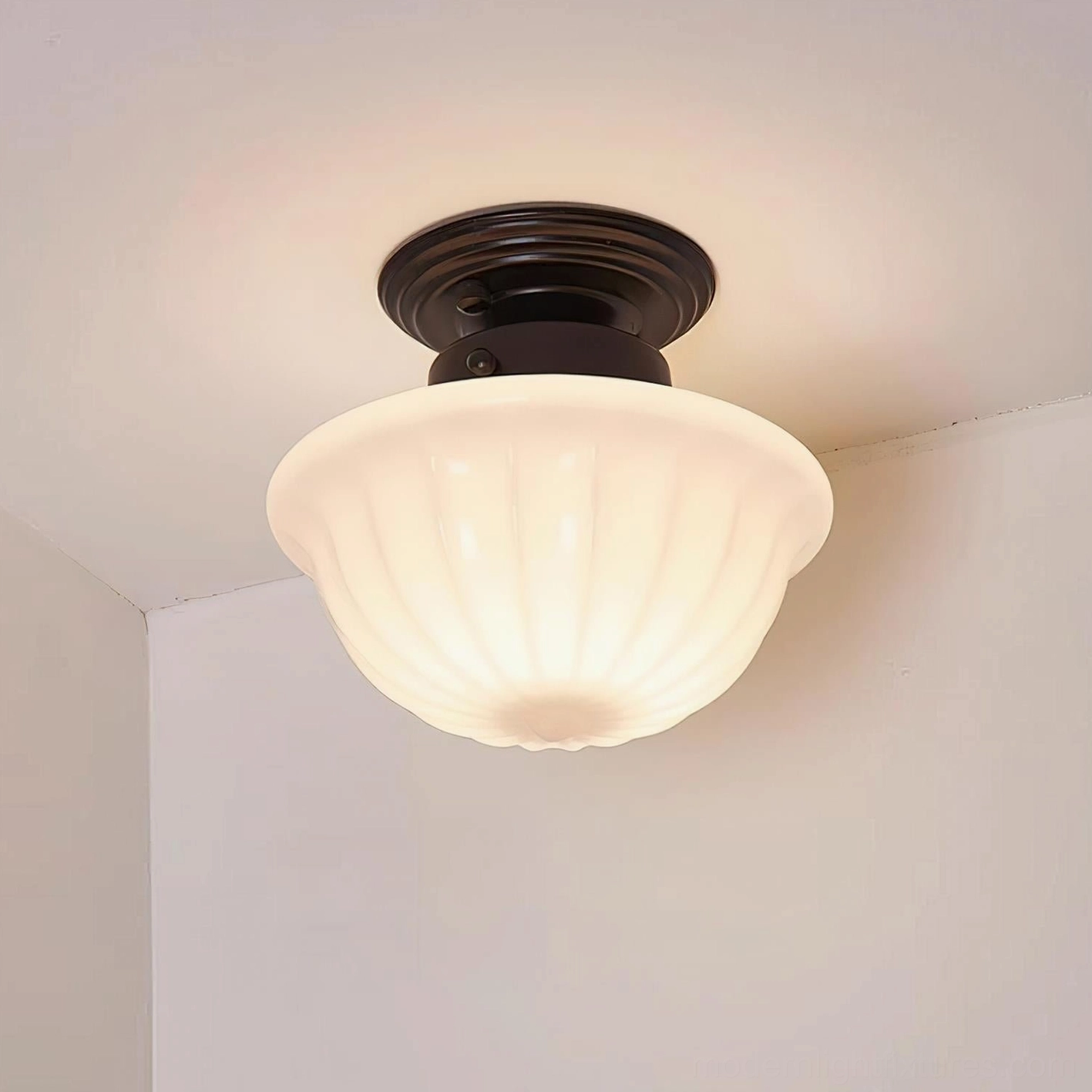 Close-up view of Ritten semi-flush ceiling light showing ornate black metal base and complete ribbed glass shade