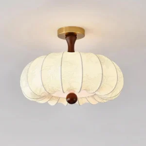 Close-up front view of Rivale modern ceiling light showing embossed floral fabric shade with brass and wood hardware