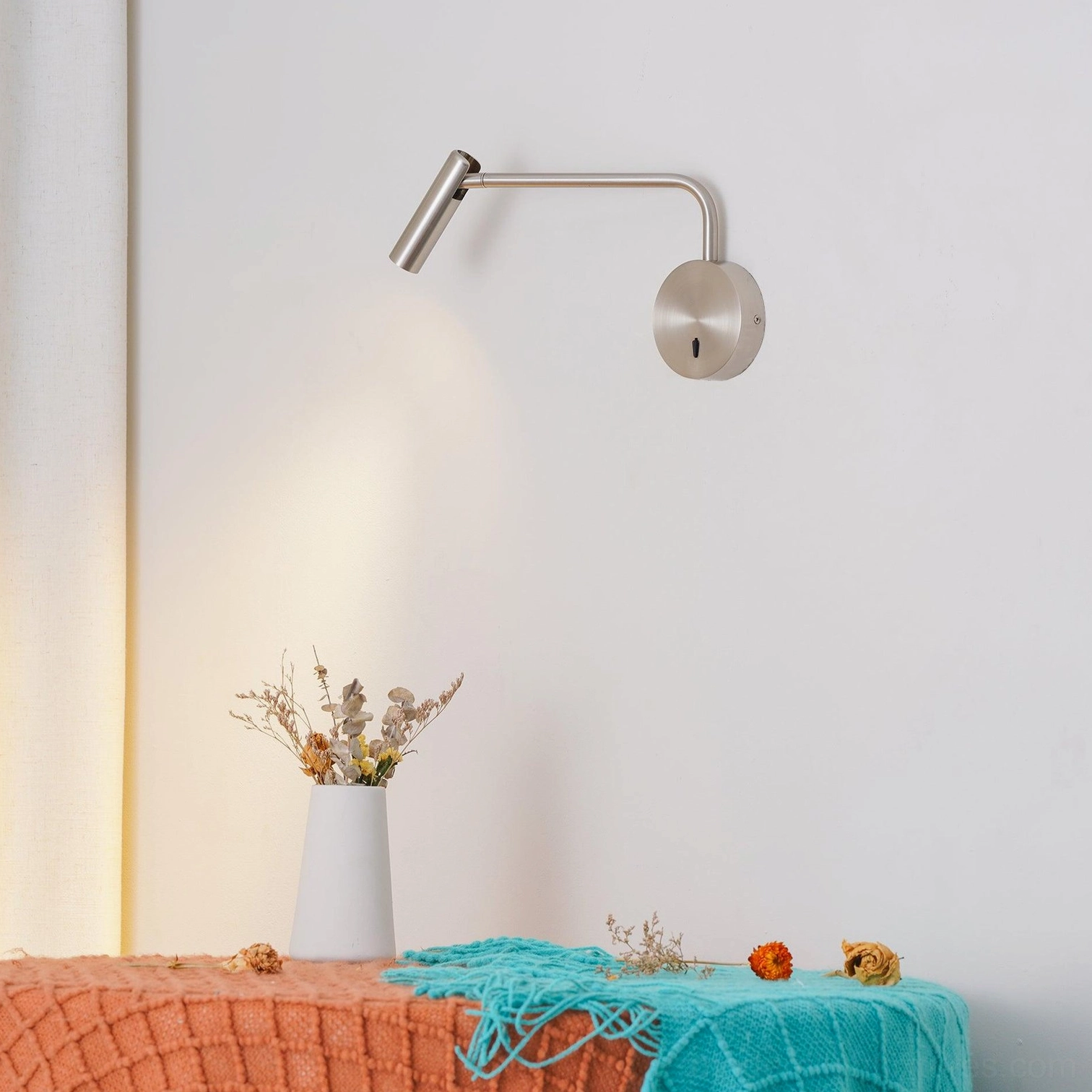 Rizo reading wall sconce arm folded flat against disc base when not in use