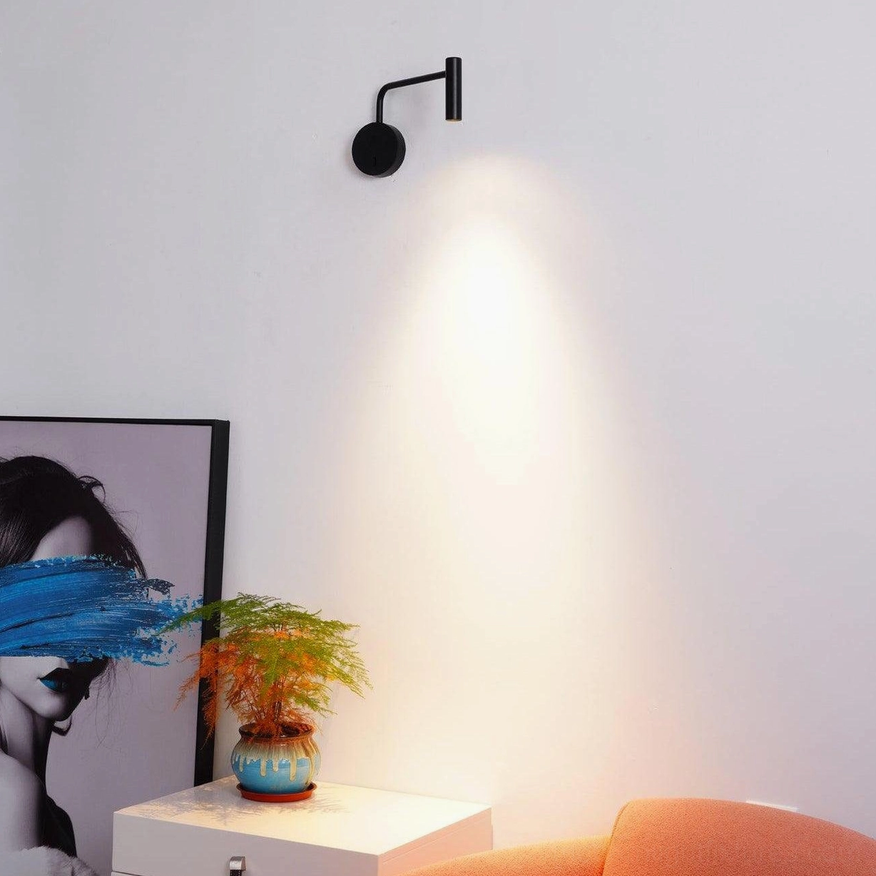 Rizo plug-in wall lamp arm rotated toward wall creating soft ambient light scatter