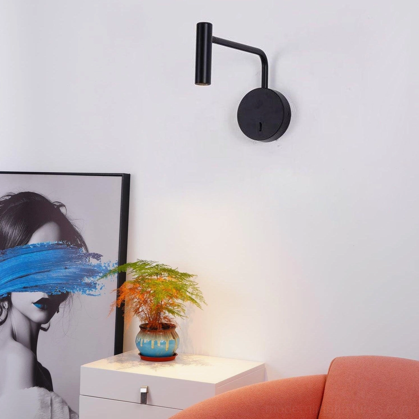 Rizo wall lamp tilted arm position aiming focused light beam downward reading