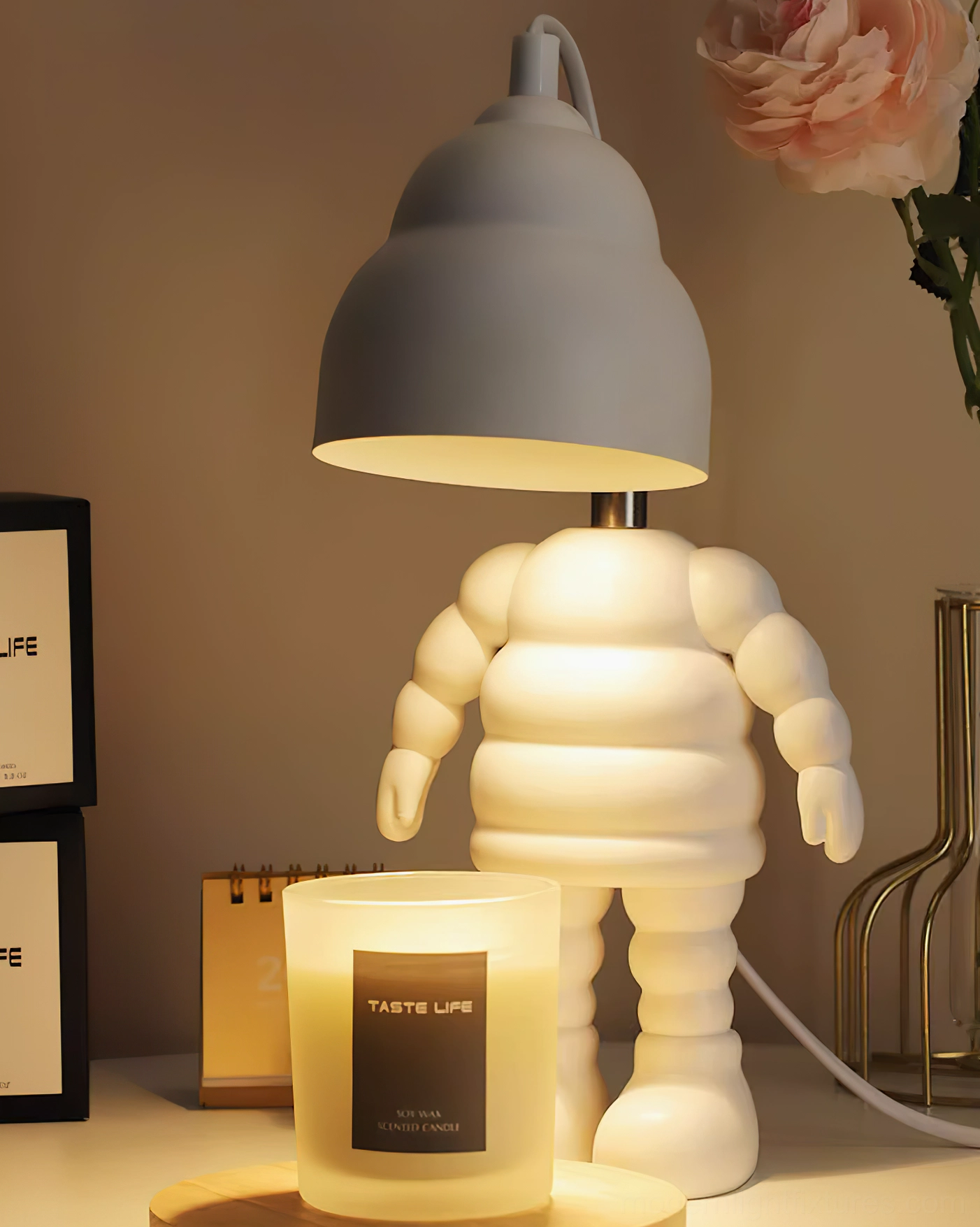 Modern robot candle warmer lamp with grey dome shade glowing warm light on bedroom nightstand