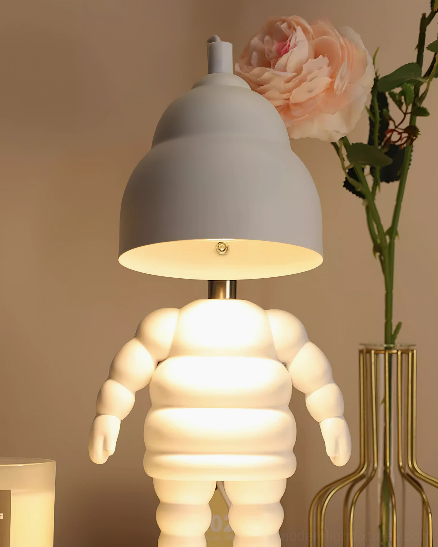Close-up three-quarter view of white robot candle warmer lamp with grey adjustable dome shade and glowing interior