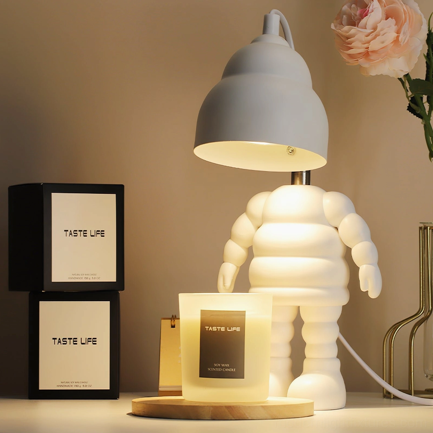 Robot-shaped candle warmer lamp with metal support rod and adjustable positioning for optimal light distribution