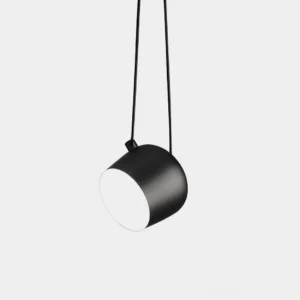 Ronan modern pendant light - matte black cylindrical shade, minimalist design, studio view