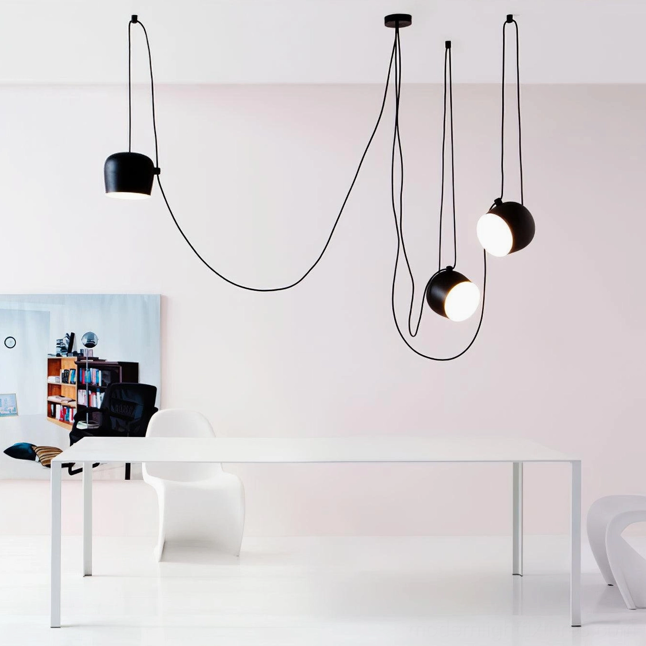 Ronan curved multi-drop pendant light over minimalist dining workspace, Scandinavian design with black cylinder shades