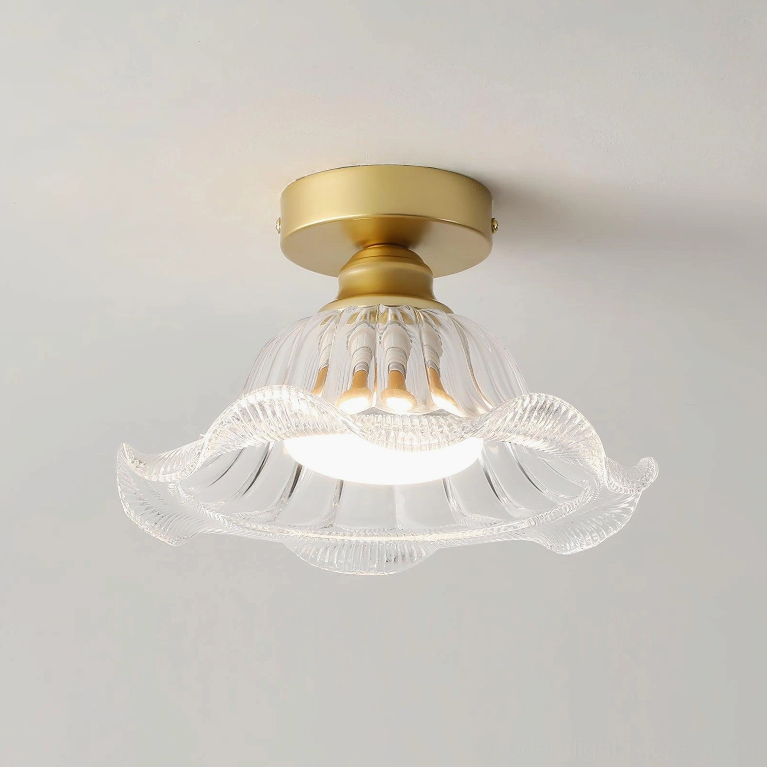 Rosa geometric glass ceiling light fixture with clear ruffled shade and polished brass canopy, product showcase