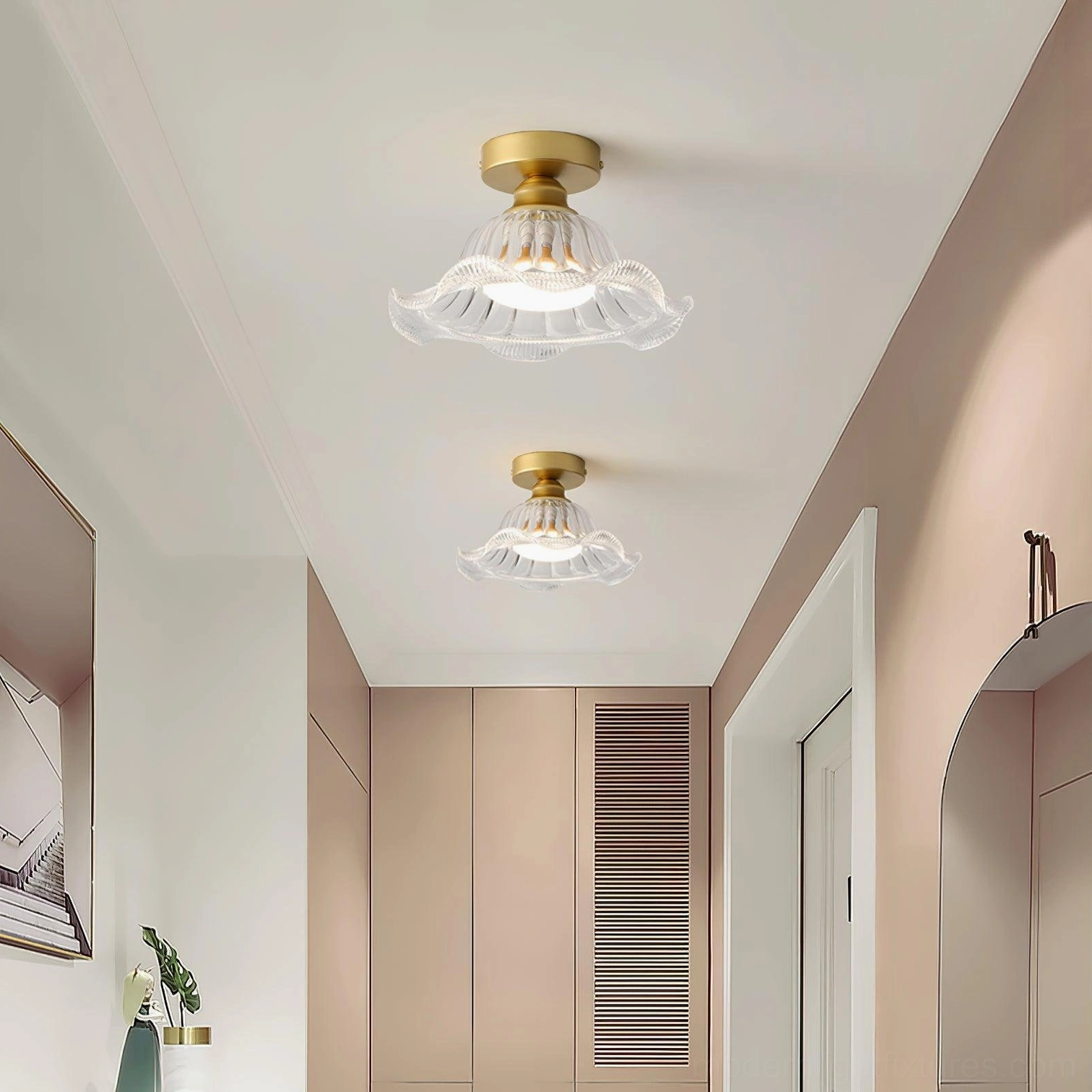 Twin Rosa geometric glass flush mounts in warm-toned entry hallway with brass hardware and wooden cabinetry