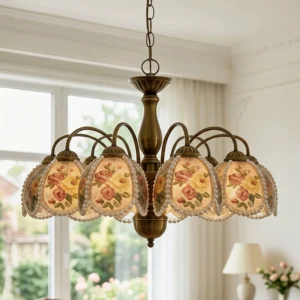 Rosabelle romantic French country chandelier installed in sunlit classic living room with curved brass arms and floral glass shades