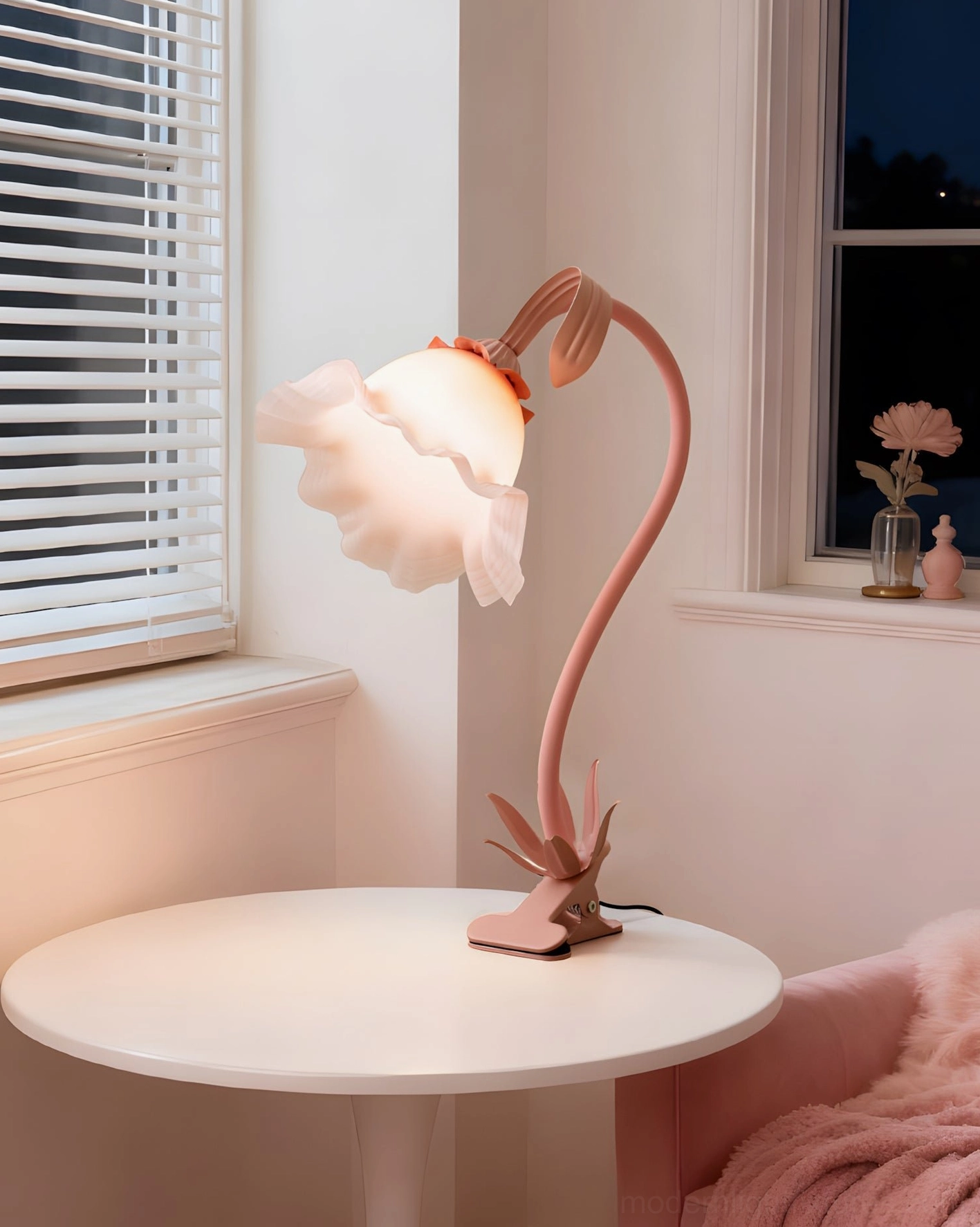 Soft pink Rosalie floral desk lamp on window-side table with cozy throw blanket and interior décor