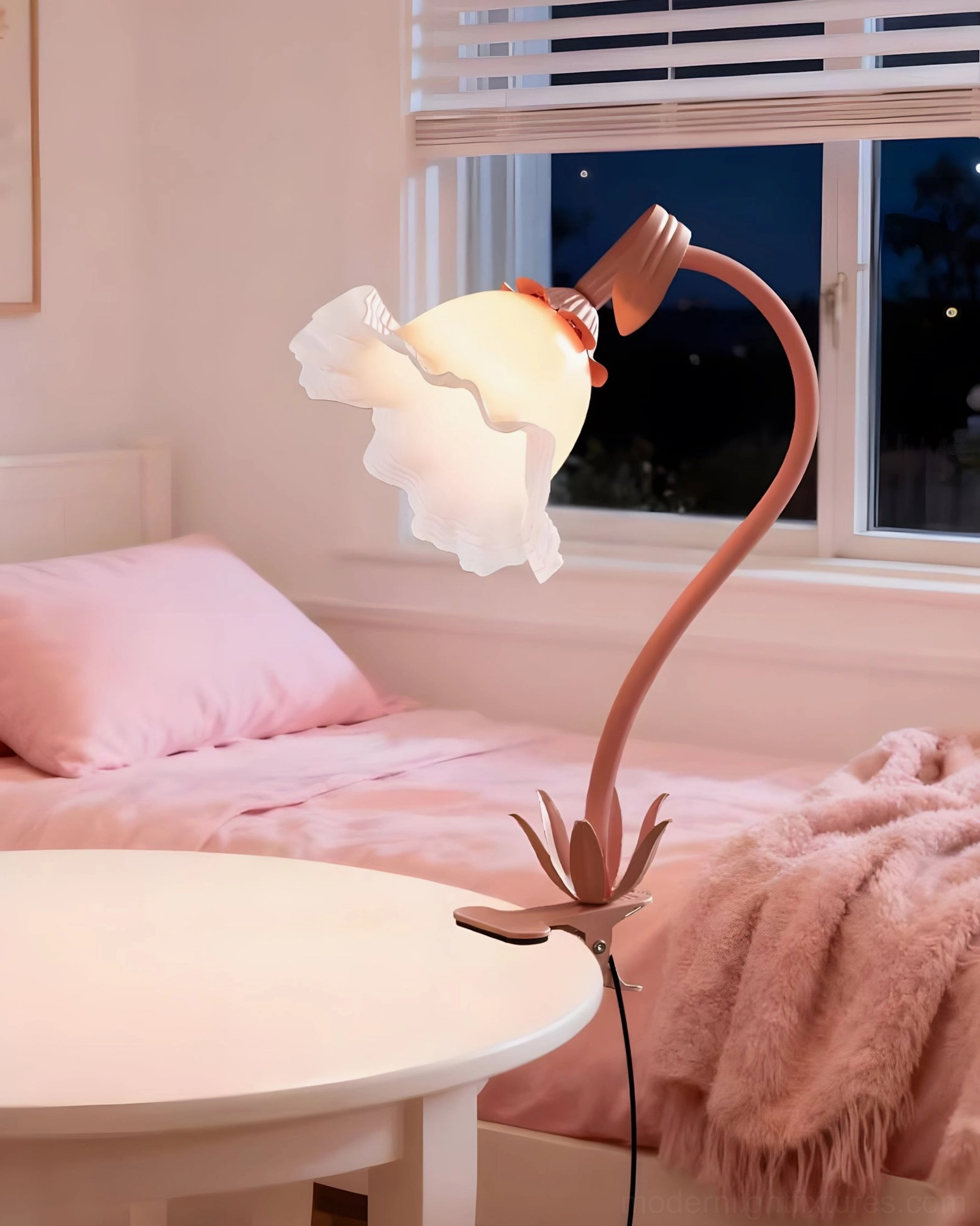 Blush pink Rosalie sculptural table lamp on bedroom bedside creating warm ambient lighting in feminine décor