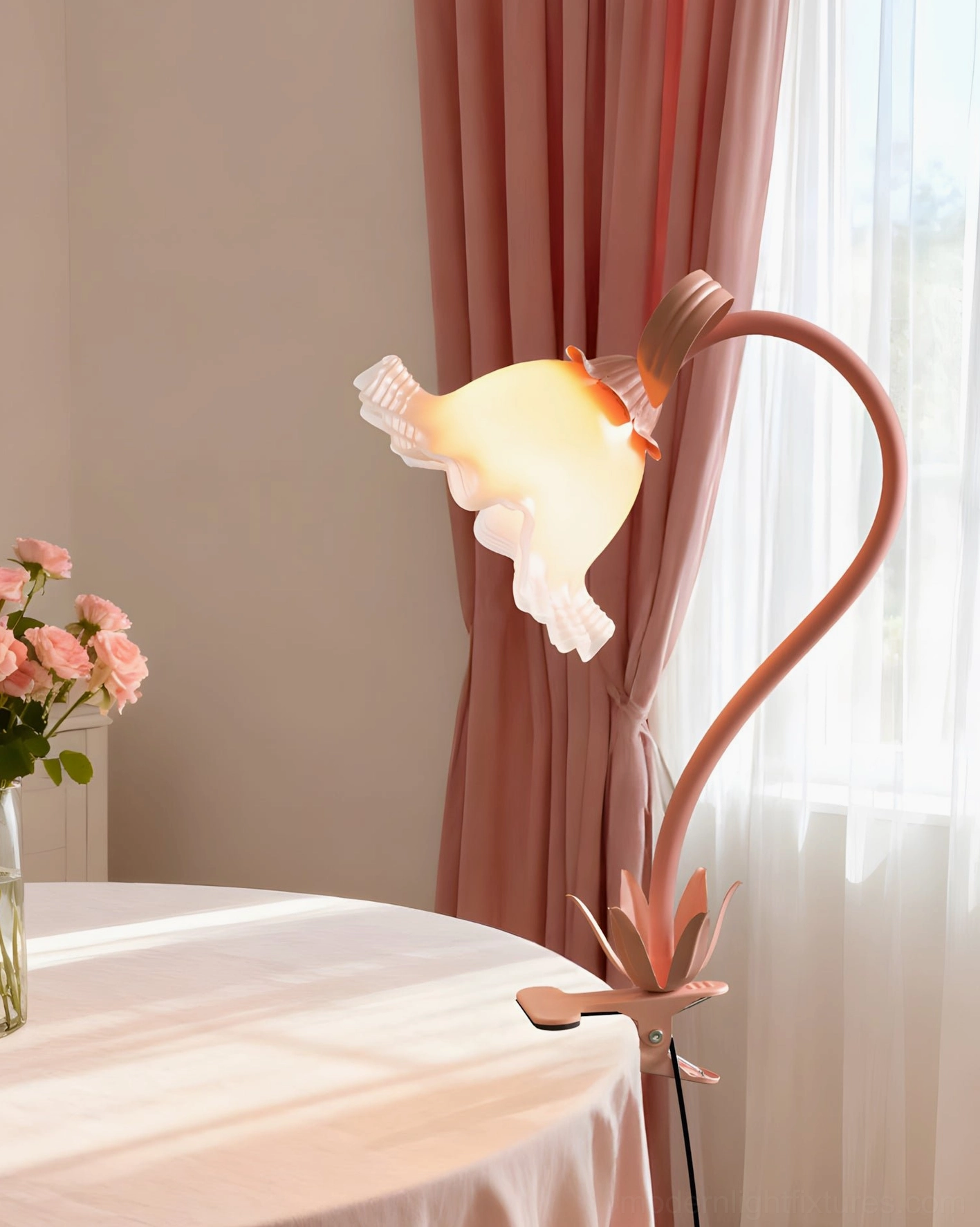 Blush pink Rosalie table lamp on dining room side table with pink flower vase and window natural light