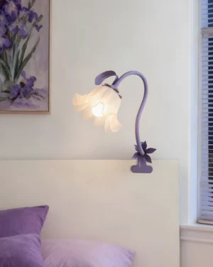Lavender purple Rosalie sculptural table lamp on bedroom headboard with matching floral wall art and botanical décor