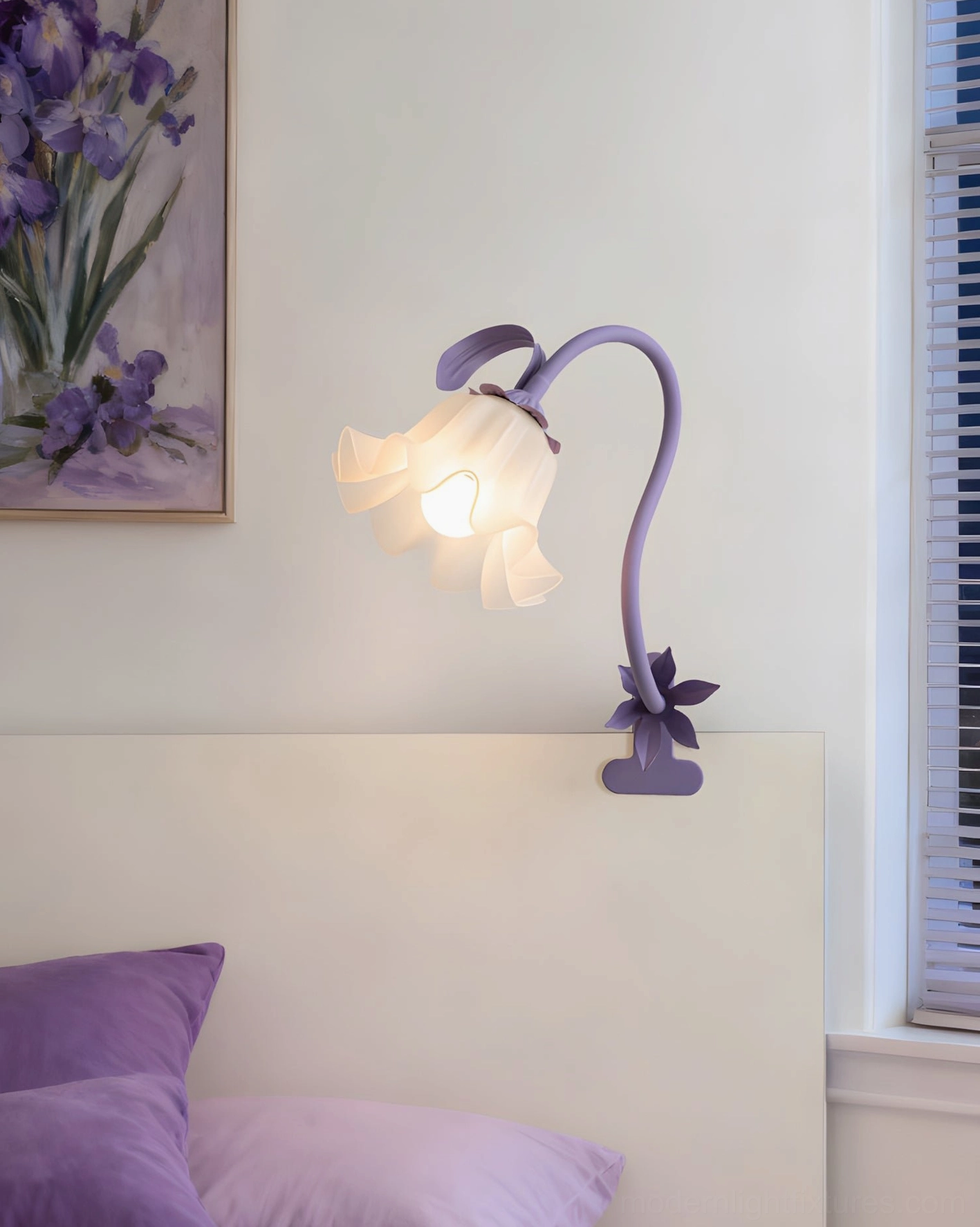 Lavender purple Rosalie sculptural table lamp on bedroom headboard with matching floral wall art and botanical décor