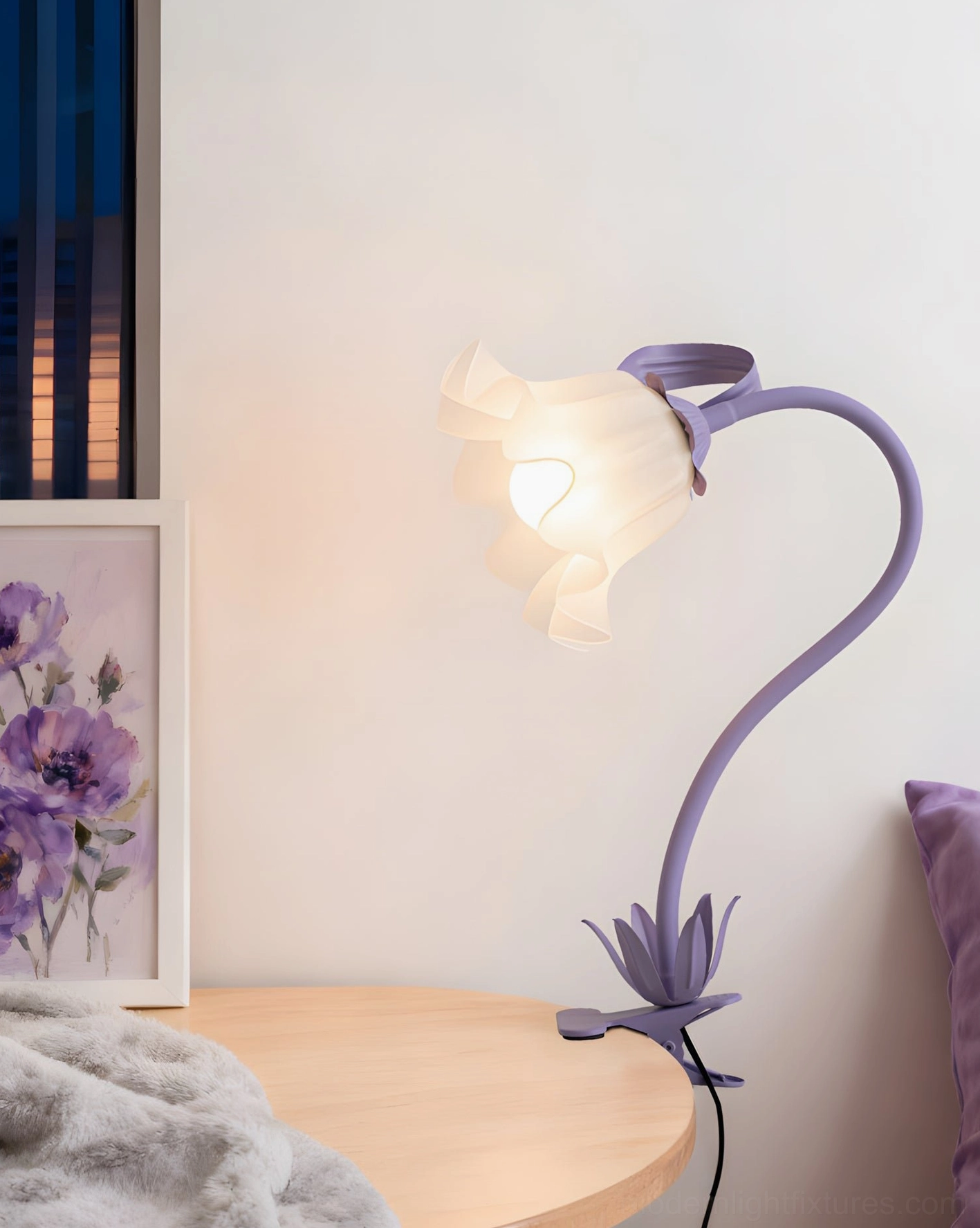 Lavender purple Rosalie sculptural lamp on wooden side table with lit frosted glass shade and framed wall art