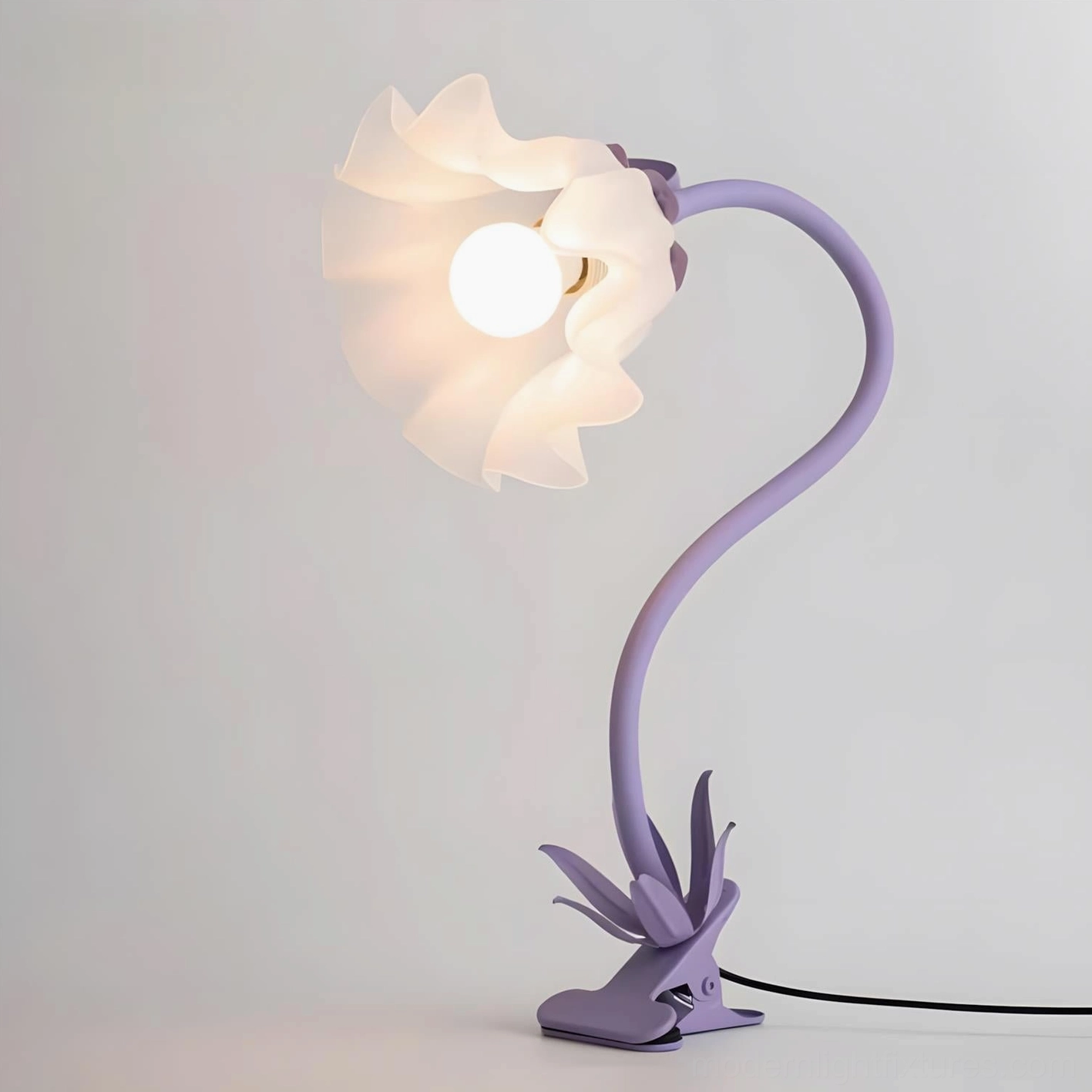 Rosalie sculptural floral lamp in vivid red color on side table with home décor accessories styling