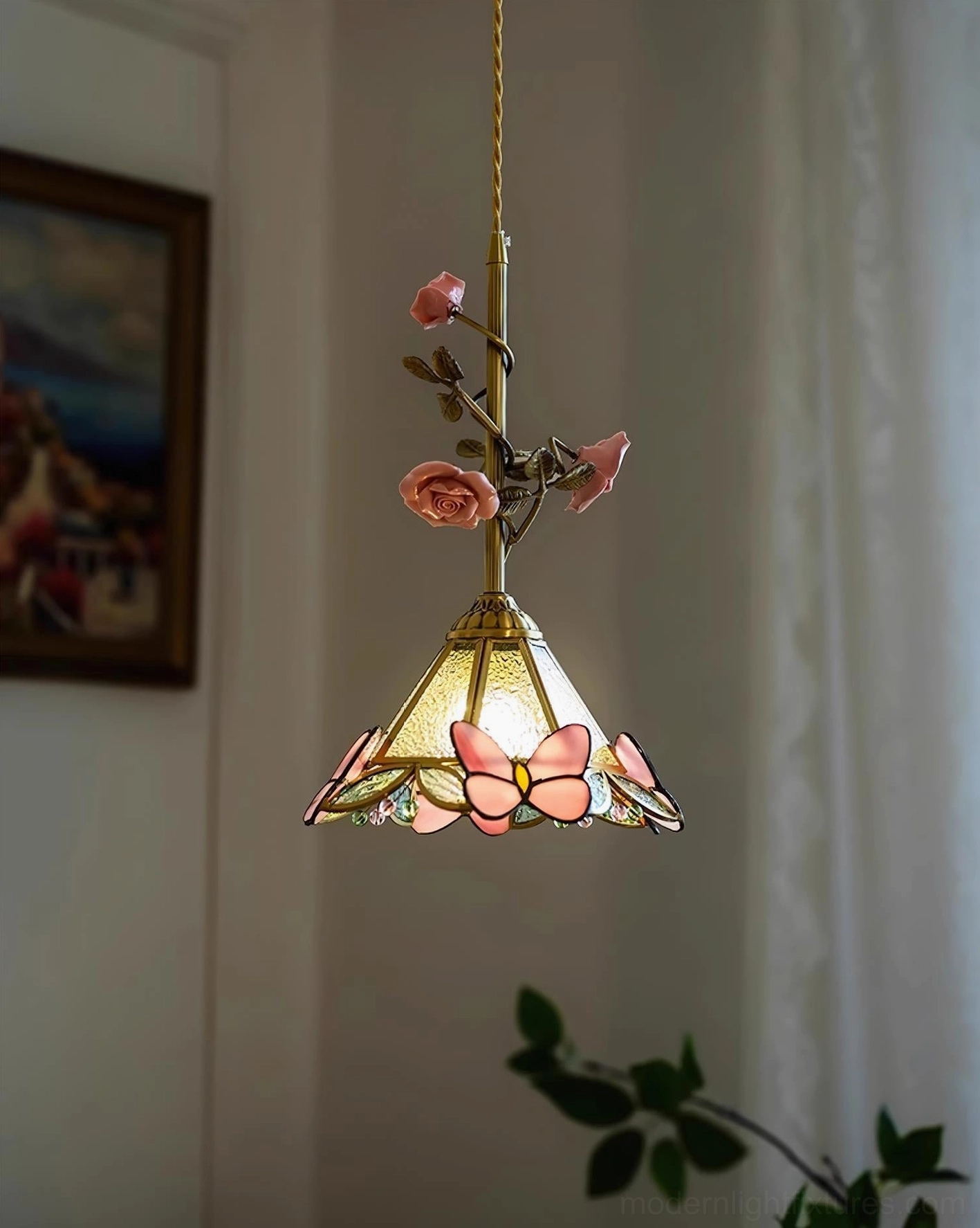 Rosavine pendant light in bedroom setting, creating romantic ambient lighting with pink shade and brass accents