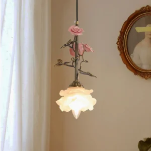 Small model Rosavine pendant lamp with pink rose-shaped shade and brass hardware, indoor warm lighting display