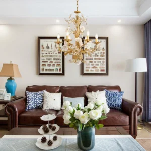 Elegant gold white rose chandelier installed above luxury leather sofa in American living room