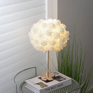 Rose garden accent lamp displayed on side table with green potted plant and elegant interior styling