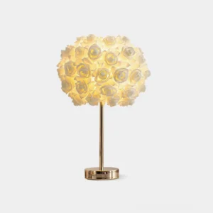 Romantic rose garden table lamp with sculptured floral shade and polished rose gold metal base on white background