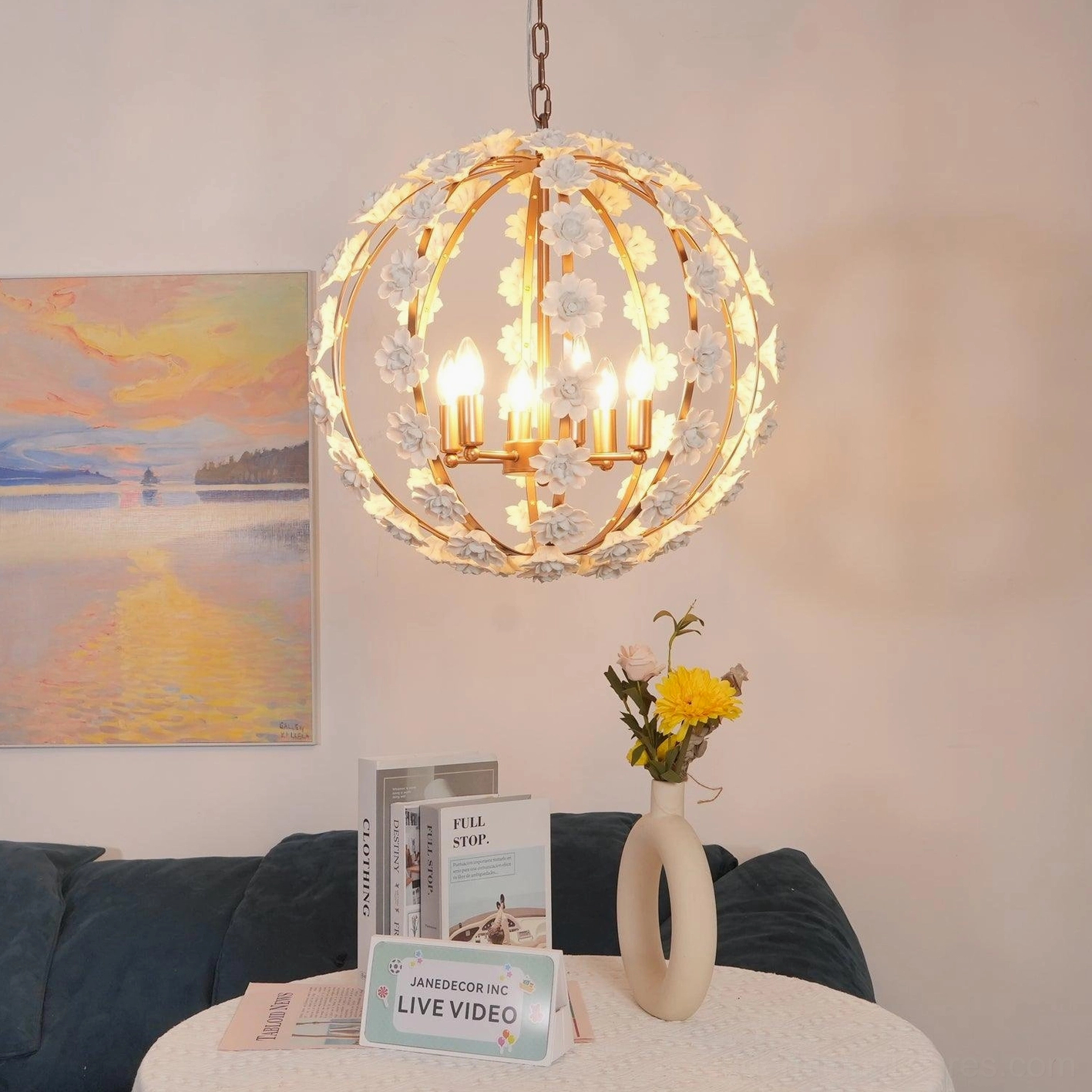 Rose gold and white ceramic flower globe pendant light with multiple lit candle bulbs