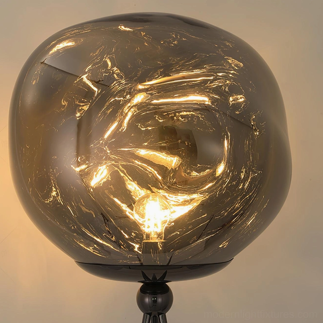 Modern tripod floor lamp with rose gold frame and artistic molten glass shade accent lighting