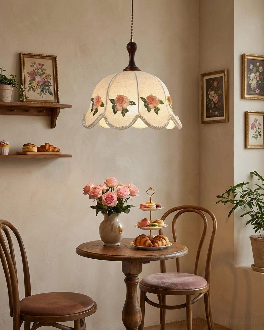 Rose printed scalloped linen pendant light with vintage wood furniture, low angle view in cafe-style dining nook