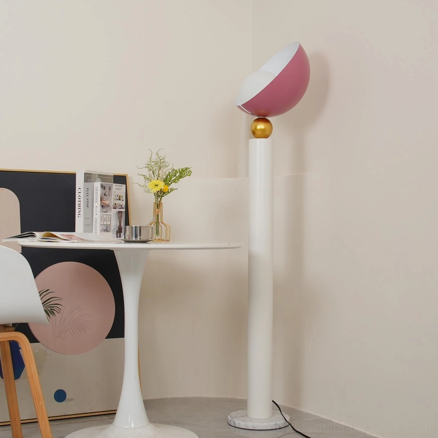 Rose red half-sphere floor lamp in contemporary dining nook with small round table, minimalist interior styling