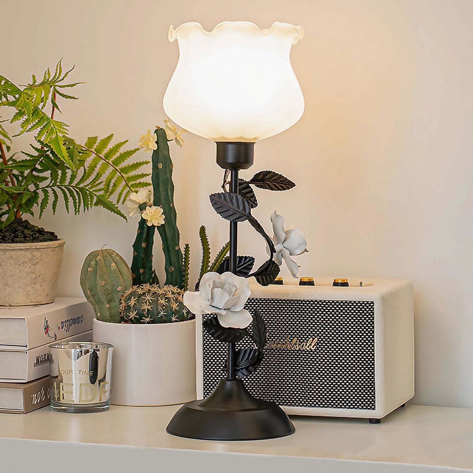Roselith boho style floral table lamp three-quarter side view on home shelf with potted plants and retro radio, natural indoor lighting