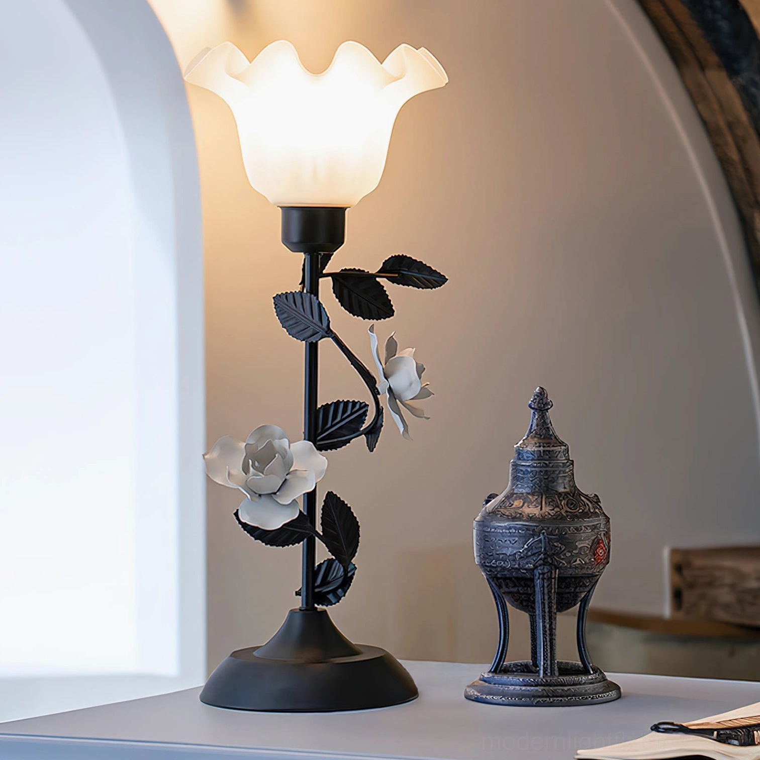 Roselith romantic floral table lamp low angle side view on console table with vintage décor, arched wall background with ambient warm lighting