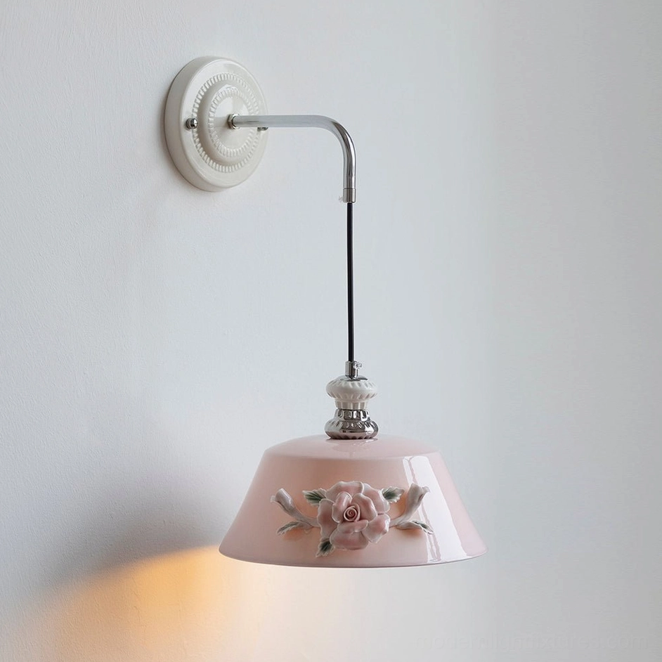 Model A Roselune pink ceramic wall sconce with wide dome shade and three-dimensional hand-sculpted botanical motifs
