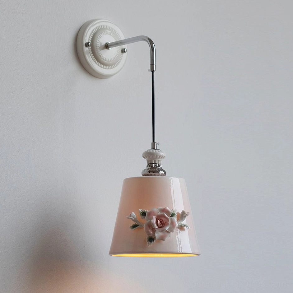 Model B Roselune pink tapered ceramic wall sconce in bedroom interior with vertical proportions and romantic aesthetic